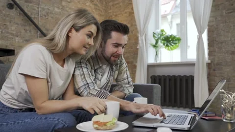 Couple having video call during their lunch break on laptop Video stock 233435968