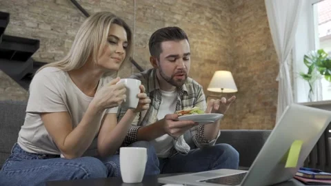 Couple having video call during their lunch break on laptop Stock Footage 233436144