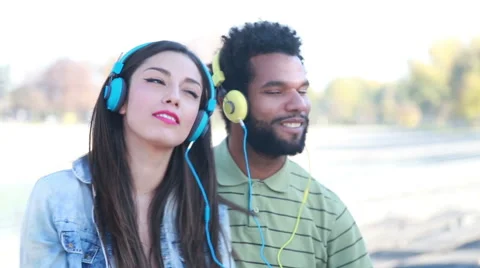 Couple with headphones listening to music and dancing to the rhythm Stock Footage 59555035