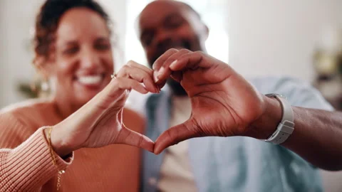 Couple, heart hands and bonding with smile in home, together and connection with Stock Footage 338372448