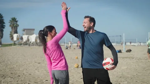 A Couple High Fives While Playing Volleyball Stock Footage 233386680