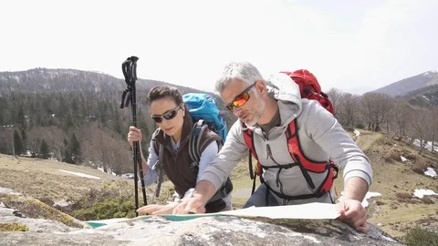 Couple of hikers reading orientation map Stock Footage 88926336