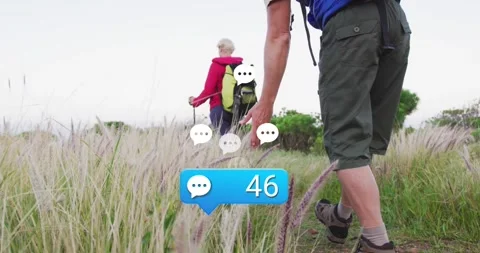 Couple hiking path with trekking poles, social media bubble appearing and Stock Footage 327645264