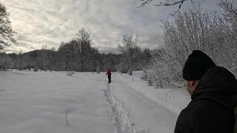 Couple hiking through the snow Stock Footage 326716113