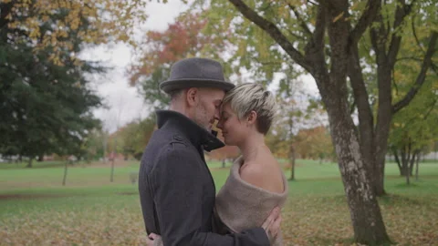 Couple Hold Each Other Close While Standing Outside in an Autumn Park 库存影片 208723944