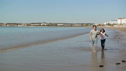 Couple Hold Hands on Background Beach Ocean Sunrise. People Cuddling and Looking Stock Footage 86078251