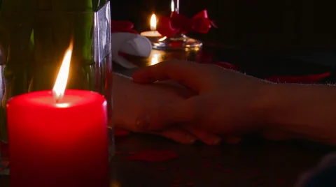 Couple hold Hands with a Candle in the Foreground Video stock 59345971