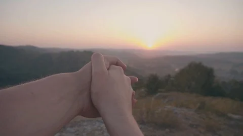 Couple hold hands on sunset background Stock Footage 99228597