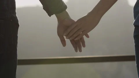 Couple hold hands on sunset Stock Footage 100923905