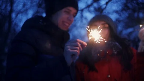 Couple holding bengal light at night,romantic,light bokeh, winter forest Stock Footage