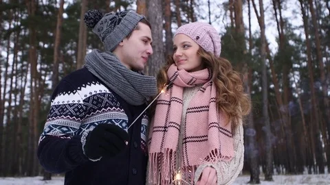 Couple holding bengal light in the winter forest Stockbeeldmateriaal 70989248