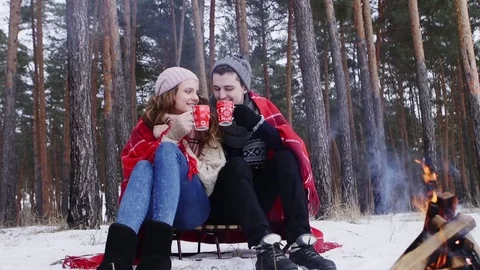 Couple holding bengal light in the winter forest slider shot Stock Footage 70989422