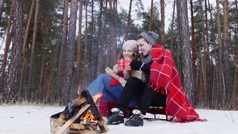 Couple holding bengal light in the winter forest slider shot Video stock 70989588