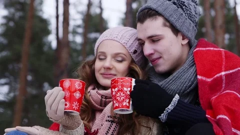 Couple holding bengal light in the winter forest slider shot Stock Footage 70989607