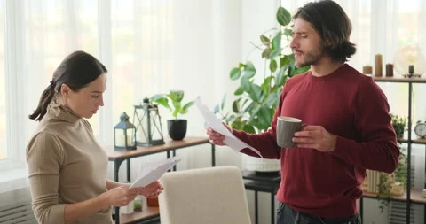 Couple holding documents and discussing Stock Footage 145225378