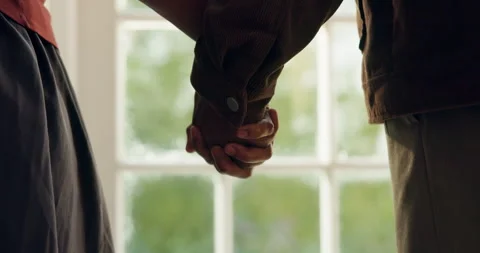 Couple, holding hands and bonding with partner, home and commitment for Stock Footage 337541559