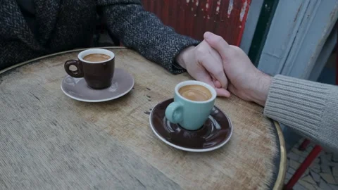 Couple holding hands and moving apart over a cup of coffee Stock Footage 277799464