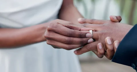 Couple, holding hands and ring for marriage, commitment or wedding in ceremony Stockbeeldmateriaal 250991215