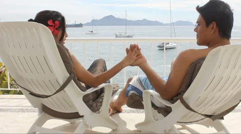 Couple holding hands by the beach Stock Footage 1092699