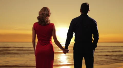 Couple holding hands on the beach. Stock Footage 43680936
