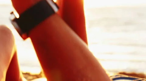 Couple holding hands on a beach at sunset Stock Footage 52947553