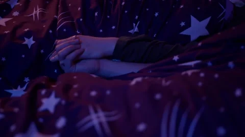Couple Holding Hands in Bed Preparing for Sleep Night Stock Footage 145842261