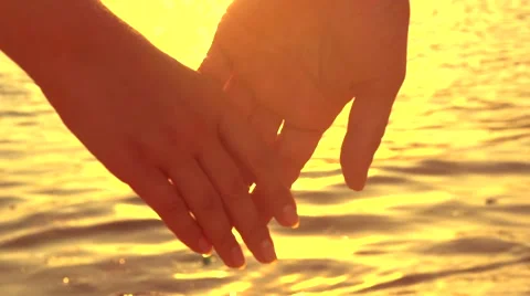 Couple holding hands over blinking sea background Stock Footage 50069933