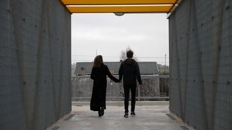 Couple holding hands separation break up walk away to different sides end of rel Stock Footage 97953993
