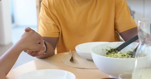Couple holding hands shifting hands locking showing affection at table with 스톡 동영상 338435796