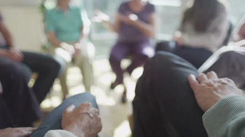 Couple holding hands for support during group therapy session. Focus on hands Stock Footage 44684284