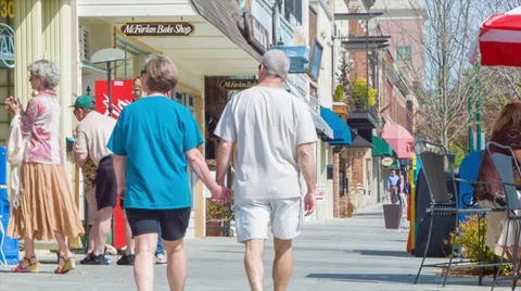 Couple Holding Hands Walking Down a Busy Hendersonville, NC Stock Footage 39590150