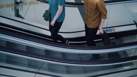 Couple Holding Hands Walking Up Escalator at Modern Airport Stock-Footage 334566643