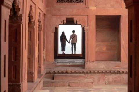 Couple holding hands while visiting a Fatehpur Sikri, Uttar Pradesh. Stock Photos