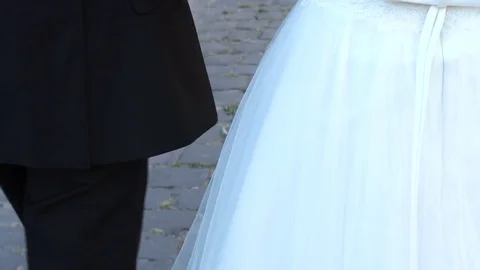 Couple holding hands while walking in the park near the old castle. Slow motion Stock Footage 82836006