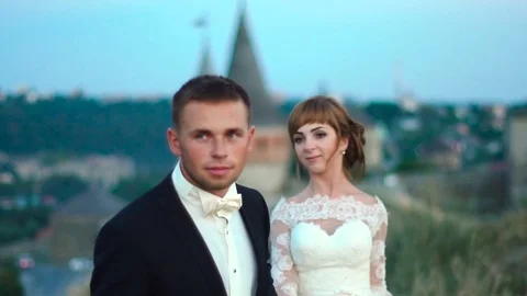 Couple holding hands while walking in the park near the old castle. Slow motion Stock Footage 82837253