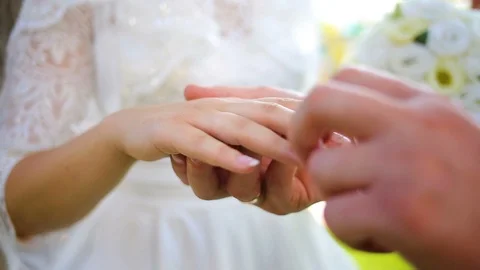Couple holding hands while walking along sunny park and tenderly kissing Stock Footage 96021973