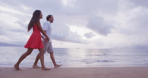 Couple Holding Hands While Walking On Beach Stock Footage 102283644
