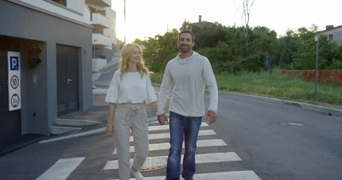 Couple Holding Hands While Walking In Peaceful Neighborhood Stock Footage 124148174