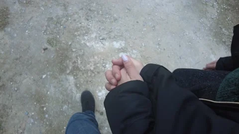 Couple holding hands while walking in their coats in winter. Stock Footage 232437348