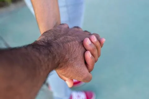 Couple holding hands while walking Stock Photos