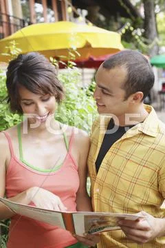 Couple holding restaurant menu Stock Photos