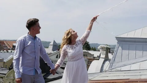 Couple holding some ballons on the rooftoop. Stock Footage 81296951