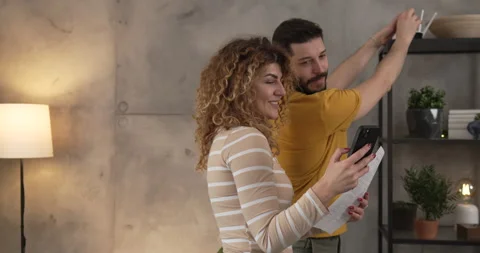 Couple at home connect and install cctv security surveillance camera Stock Footage 264782456