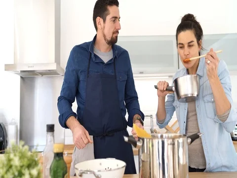 Couple at home having fun cooking together Stock Footage 84004068