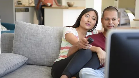 Couple at home in sofa watching movie on tv Stock Footage