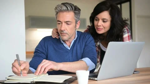 Couple at home using laptop computer Stock Footage