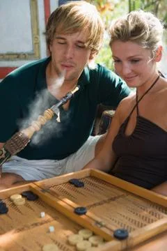 Couple with hookah and backgammon Stock-Fotos