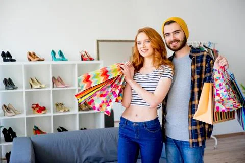 Couple hopping in a mall Stock Photos