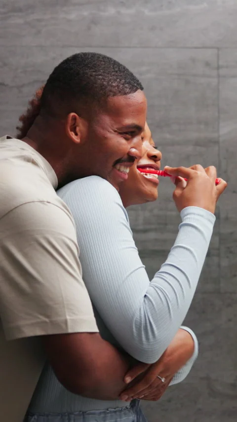 Couple, hug and brushing teeth in bathroom, bonding and laugh with partner in Stock Footage 340825163