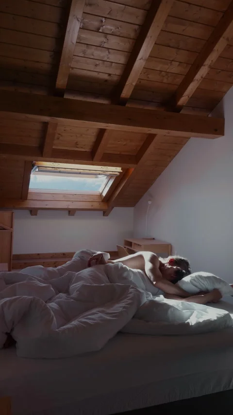 Couple hugging in bed under soft sunlight romantic home scene Video stock 332558264